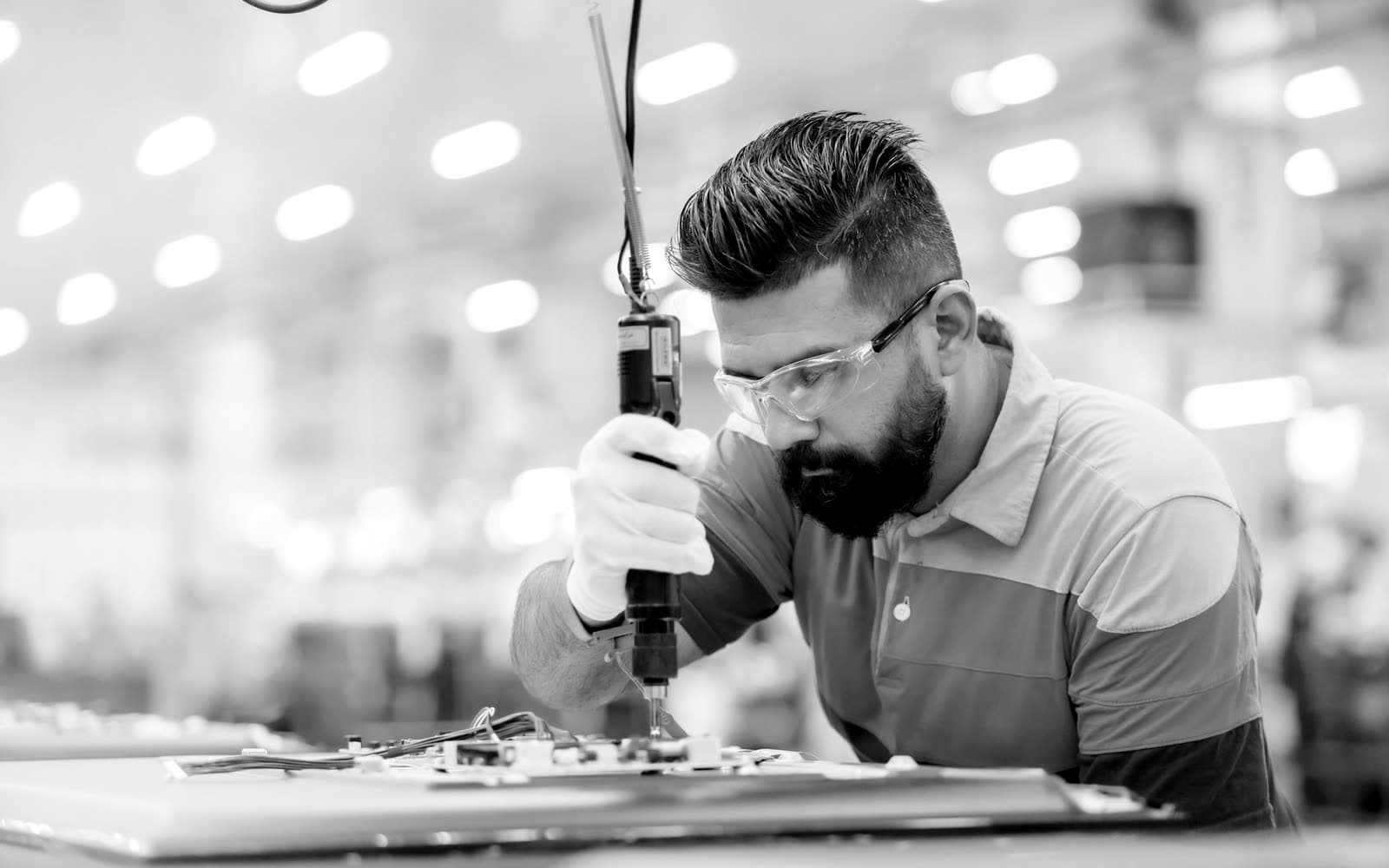 Engineer working on a piece of equipment in a factory