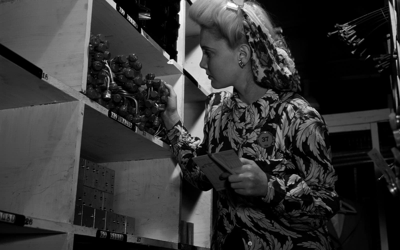 Stock-room clerk checking parts numbers against the shelves
